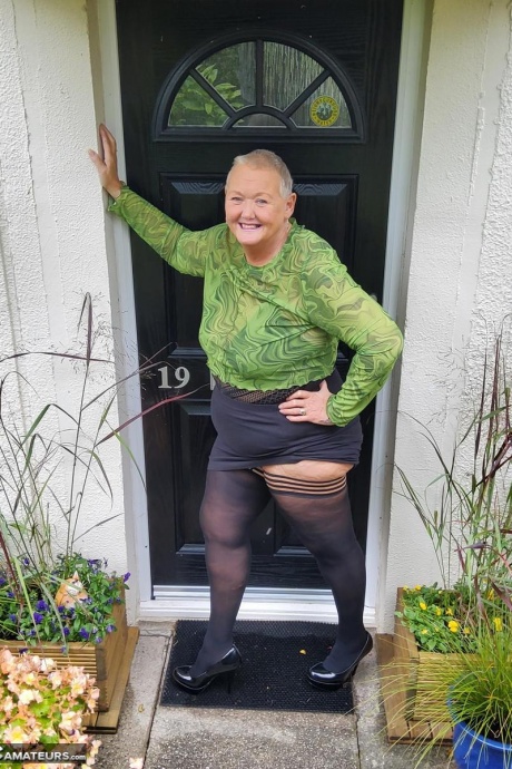 Коротко стриженная Нэн Валгасмик обнажает свои трусики под юбкой в чулках 16